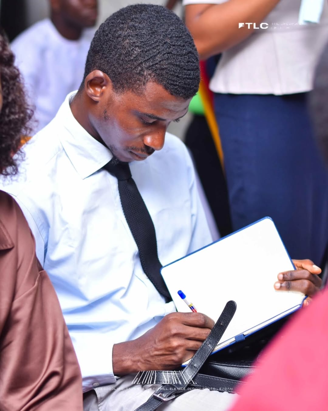 A member taking notes during teaching